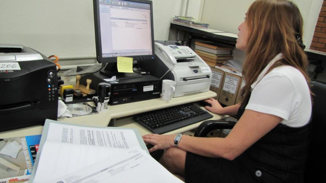 Zaměstnankyně volebního střediska ukazuje počítač, kam se údaje z disket nahrávají