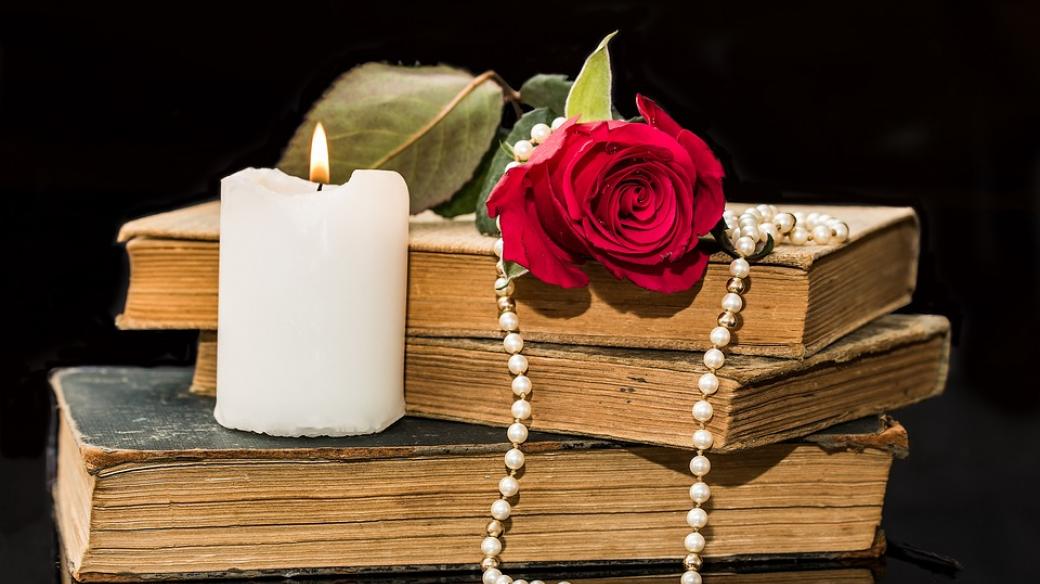Knihy básní se svíčkou, růží a perlami