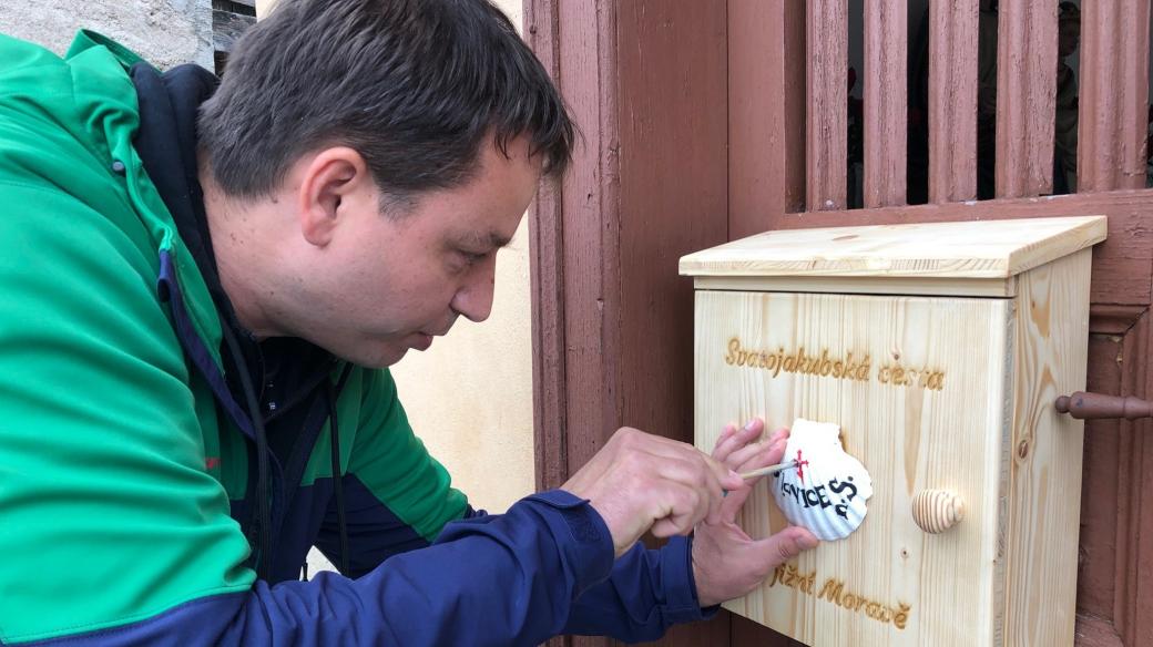 Dřevěné boxy označené bílou mušlí najdou lidé u kostelů nebo kaplí
