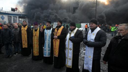 Duchovní různých vyznání se modlí během střetů demonstrantů s policií v centru Kyjeva (23. ledna 2014)