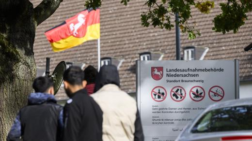 Migranti stojící před státním přijímacím úřadem v Dolním Sasku (říjen 2023)
